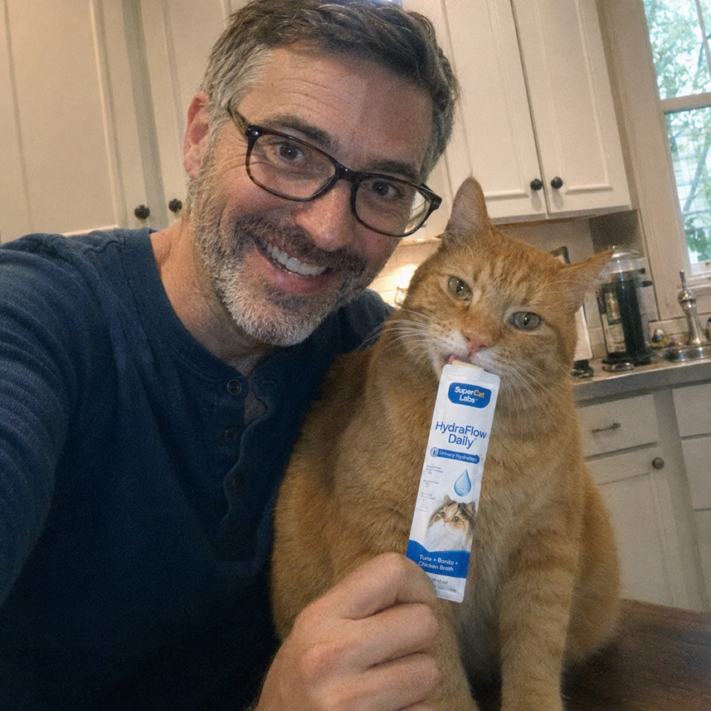 Cat parent with orange cat licking SuperCat sachet