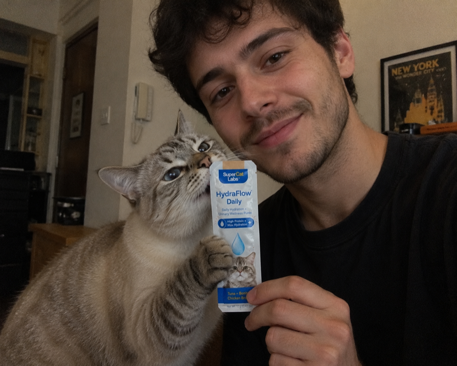 Cat parent holding SuperCat HydraFlow Daily with a cat
